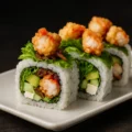 Indulge in the luxurious flavors of the Lobster Roll , a true seafood delicacy. This elegant roll combines creamy avocado, crisp cucumber, fresh lettuce, and sweet caramelized onions with rich cream cheese for a luscious base. The star of the roll is the generous chunks of tempura-fried lobster, adding a crispy, buttery texture that elevates every bite. Perfectly balanced and decadently delicious, this roll is a celebration of premium ingredients and refined taste.