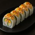 Mango Crab Maki California topped with tobiko, sesame seed, scallion with crab salad, mango and citrus mayo.