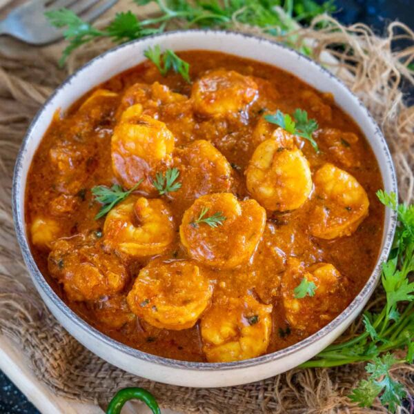 Succulent shrimp simmered in a rich, spiced tomato sauce with garlic, ginger, and coconut milk for a creamy kick. Perfectly balanced with bold flavors, this curry pairs beautifully with rice or naan. A quick, flavorful treat for seafood lovers.